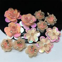 a bunch of pink flowers with pearls on them