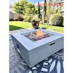 an outdoor fire pit sitting on top of a rug