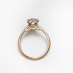 a gold ring with a diamond on it