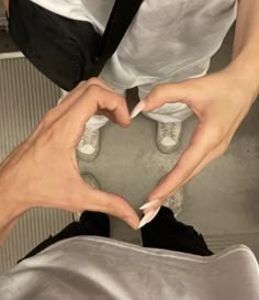 two people making a heart with their hands