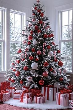 a decorated christmas tree with red and white ornaments