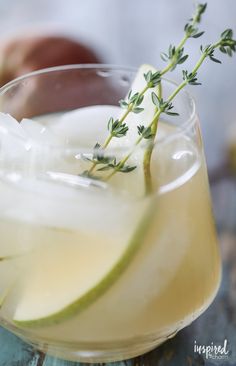 an apple cider is garnished with fresh herbs