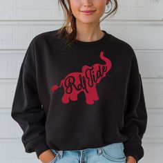 *Also available as a t-shirt. See below.* Get ready for game day and show your team pride with our Roll Tide Elephant Football Sweatshirt! This warm and cozy crewneck sweater is perfect for any Alabama fan. Whether you're cheering in the stands or watching from home, you'll be the most stylish fan in this Roll Tide sweatshirt. Collegiate Crew Sweater For Game Day, Game Day Crew Neck Sweater With Ribbed Cuffs, Fall Sports Fan Sweatshirt With Crew Neck, Fall Sports Fan Crew Neck Sweatshirt, Fall Crew Neck Sports Fan Sweatshirt, Fall Cheerleading Crew Neck Sweatshirt, Fall Crew Neck Sweatshirt For Cheerleading, School Spirit Crew Sweatshirt For Game Day, Black Sweatshirt For Cheerleading In Fall