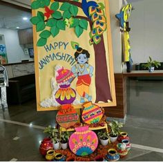 there is a sign that says happy janmashth with decorations on the table