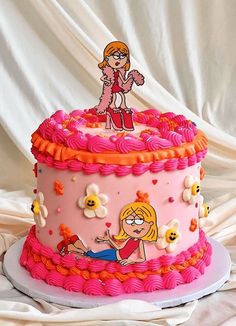 a pink and orange cake with cartoon characters on it's top, sitting on a white surface