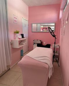 a pink room with a white bed in it