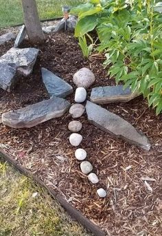 a cross made out of rocks in the ground