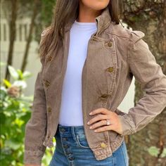 This cropped military style denim jacket is sure to turn heads with it's high neck and gold button detail. Puff sleeves and fitted waist. Perfect casual weekend jacket. Measurements laying flat: Bust - 17" Waist - 16 1/2" Shoulder to hem - 21" Shoulder to shoulder - 15" Military Style Cotton Denim Jacket For Winter, Brown Denim Outerwear With Button Closure, Spring Military Style Cotton Denim Jacket, Brown Denim Jacket, Khaki Military Outerwear With Button Closure, Brown Military Outerwear With Button Closure, Vintage Military, Military Fashion, Denim Fashion