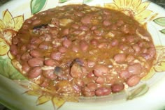 a bowl filled with beans sitting on top of a table