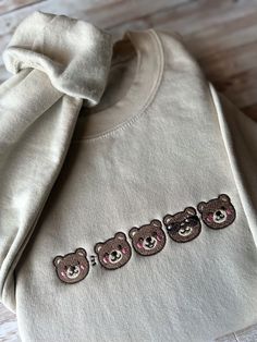 Snuggle up in our Adorable Teddy Bear Embroidered Sweatshirt - a must-have for cozy winter fashion! This cute bear design adds a touch of warmth and style to your wardrobe. Soft, versatile, and unisex, it's the perfect casual comfort for all ages. Embrace the trend with this lovable teddy bear-themed apparel. Whether you're looking for a unique gift idea or trendy winter wear, our soft and warm sweatshirt with intricate embroidery is the ideal choice. Stay fashionable and comfortable in this bear-hug of a garment! 🐻 A sturdy and warm sweatshirt bound to keep you warm in the colder months. A pre-shrunk, classic fit sweater that's made with air-jet spun yarn for a soft feel and reduced pilling. * 50% cotton, 50% polyester * Pre-shrunk * Classic fit * 1x1 athletic rib knit collar with spande Long Sleeve Cotton Tops With Bear Print, Casual Bear Design Crew Neck Top, Cotton Long Sleeve Sweatshirt With Bear Print, Winter Loungewear Tops With Embroidered Graphics, Winter Embroidered Tops For Loungewear, Casual Bear Print Tops For Fall, Cute Cotton Sweatshirt With Custom Embroidery, Cute Cotton Sweatshirt With Embroidered Logo, Winter Bear Print Cotton Top