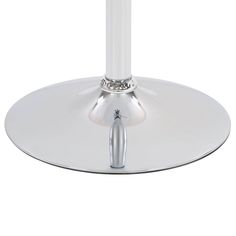 a white table with a silver base and a round glass plate on top that has a metal ring around it