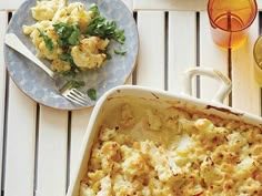 there is a casserole dish on the table next to a glass of orange juice