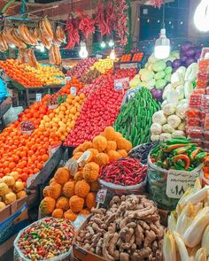 an outdoor market with lots of vegetables and fruits