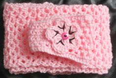 a pink crocheted case with a cat on it's face and eyes