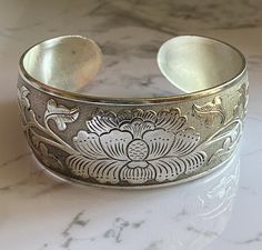 Tibetan Peony Cuff Bracelet Beautifully Made in Tibet. Makes a wonderful unique gift for you or your friend. 100% brand new and high quality, one of a kind.Material:Tibetan silver Packing includes:1pc Note: Due to the difference between different monitors, the picture may not reflect the actual color of the item. Thank you! Traditional Nickel-free Cuff Bracelet As Gift, Traditional Nickel-free Cuff Bracelet Gift, Handmade Spiritual Silver Cuff Bracelet, Handmade Silver Spiritual Cuff Bracelet, Silver Bohemian Cuff Bracelet Gift, Spiritual Silver Cuff Bracelet As Gift, Spiritual Silver Cuff Bracelet For Gift, Handmade Silver Cuff Bracelet As Gift, Handmade Silver Cuff Bracelet For Gift