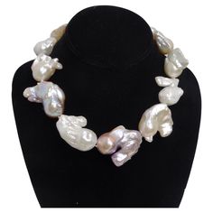 Elevate your style with the understated luxury of this classic choker-style necklace. Crafted from the most exquisite large iridescent fireball pearls, this necklace is a true testament to nature's artistry. Each pearl is a unique masterpiece, capturing and reflecting light in a mesmerizing dance of colors. Classic choker style suitable for any occasion features large iridescent fireball pearls, each one uniquely captivating. A beautiful crystal-encrusted magnetic closure adds a touch of glamour Reflecting Light, Choker Style Necklace, Understated Luxury, Baroque Pearl Necklace, Choker Style, Sparkling Crystal, Style Necklace, Baroque Pearls, Elevate Your Style