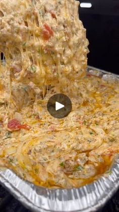 someone is adding cheese to a casserole dish