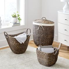 three wicker baskets sitting on top of a rug in front of a white dresser