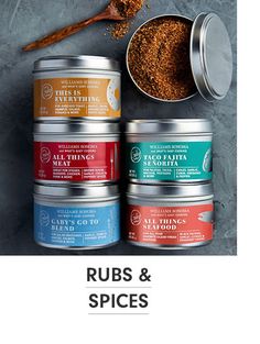 four tins of spices next to each other with the words rubs and spices on them