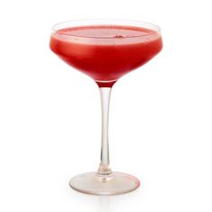 a red drink in a wine glass on a white background