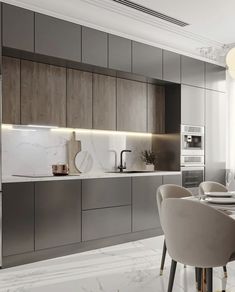 a modern kitchen with marble countertops and gray cabinets