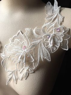 a close up of a mannequin's torso with flowers on it