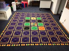 an area rug is shown in the middle of a room with chairs and desks