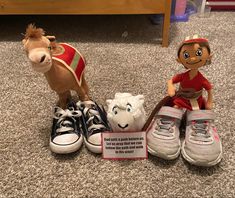 two stuffed animals sitting next to each other on the floor