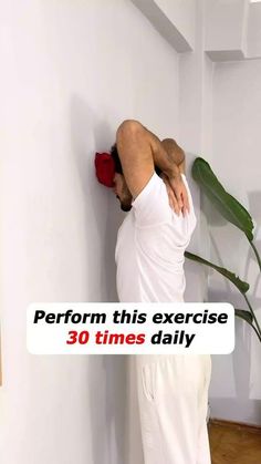 a man leaning up against a wall with his back to the wall and text reading perform this exercise 30 times daily