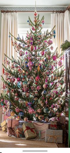 a decorated christmas tree with presents under it