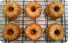 six doughnuts on a cooling rack ready to be baked