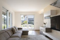 a living room filled with furniture and a flat screen tv on top of a wall