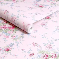 a pink floral wallpaper with blue, green and red flowers on the bottom half