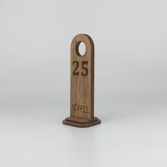 a wooden sign with the number twenty five on it that reads 25 coffee in gold lettering