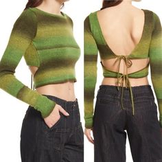 the back of a woman's sweater with green and black striped knits on it