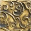 an intricately designed metal plate with swirls and scrolls