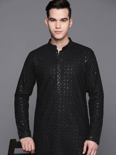 This men's Black Kurta and trousers set is perfect for special occasions. Crafted from lightweight viscose rayon, the Kurta features traditional ethnic motifs embroidered in Chikankari and two pockets with matching detailing. The trousers have a partially elasticated waistband and hook and eye closure. This classic combination offers timeless sophistication and unmatched comfort. Size & Fit The model (height 6') is wearing a size M Material & Care Top fabric: Rayon, Bottom fabric: Rayon, Dry Cle Traditional Black Bandhgala With Chikankari Embroidery, Festive Long Sleeve Traditional Kurta, Festive Long Sleeve Traditional Fit Kurta, Traditional Black Cotton Bandhgala, Cotton Long Sleeve Bandhgala For Traditional Ceremonies, Cotton Bandhgala For Traditional Ceremonies, Long Sleeve Cotton Bandhgala For Traditional Ceremonies, Black Bandhgala With Chikankari Embroidery Bollywood Style, Black Sherwani With Chikankari Embroidery For Festivals