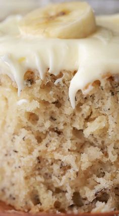 a banana cake with white frosting and bananas on top