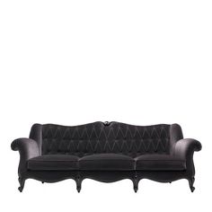 a black couch with an ornate design on the back and arms, sitting against a white background