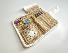 a crocheted placemat with scissors and pins on it sitting on a table