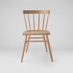 a wooden chair on a white background with no one in the room to see it