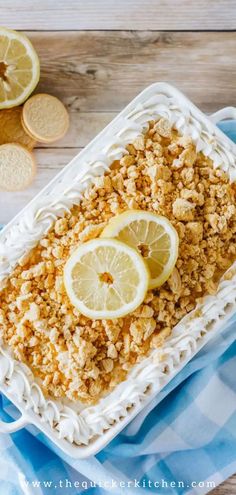 lemon crumbled dessert in a white dish on a blue and white towel