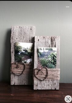 two small wooden frames with pictures on them