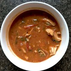 a white bowl filled with soup on top of a table