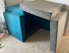 a blue bench sitting on top of a carpeted floor