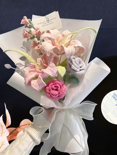 a bouquet of crocheted flowers on top of a record player's turntable