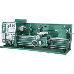 the lathe machine is green and has two machines on it's sides, one with