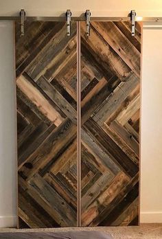 two wooden doors with metal handles in a room