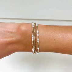 This beautiful, dainty bracelet stack is made of 2mm 14k gold filled beads and 3mm Swarovski crystal glass pearls. Each bracelet is perfect to wear on its own or part of the stack. The 14k beads can be worn in all conditions and will not fade or rust over time. Each bracelet is hand crafted and made to order. Perfect for bridesmaid gifts or for women and girls of all ages.  The stack includes a 2mm 14k gold beaded bracelet, a scattered 14k gold filled and pearl scattered beaded bracelet, and a 1 Delicate Stackable Everyday Beaded Bracelets, Delicate Stackable Beaded Bracelets For Everyday, Dainty Stackable Beaded Bangle Bracelets, Dainty Stackable Beaded Bracelets In 14k Gold, Dainty Stackable 14k Gold Beaded Bracelets, Dainty 14k Gold Stackable Beaded Bracelets, Adjustable Delicate 14k Gold Beaded Bracelet, Delicate Adjustable 14k Gold Beaded Bracelet, Dainty Yellow Gold Beaded Bracelets In 14k Gold Filled