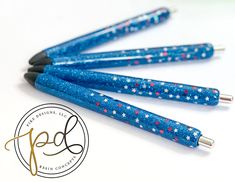 four blue pens with red, white and blue stars on them sitting next to each other